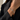 A close-up of a delicate silver chain bracelet with three butterfly motifs set with small clear stones, worn on a model's wrist. The model is wearing a black blazer.