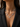 A close-up of a model wearing a silver butterfly necklace adorned with sparkling clear stones, styled with a black blazer.
