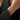 A delicate bracelet with three yellow gold butterfly charms and small clear stones on a silver chain, shown worn on a person's wrist.
